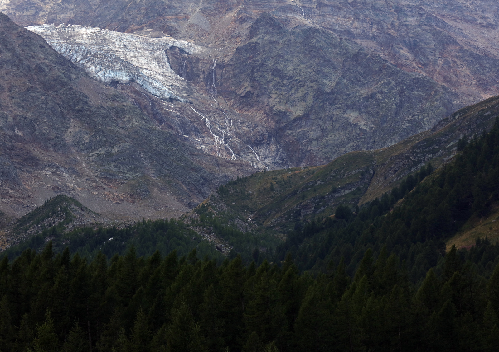 Sharp snow-dusted rock spires emerging from cloud